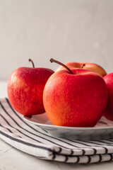 Red fresh apples in bowl on white background.