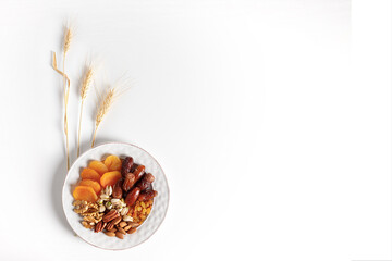 Dried fruits and nuts mixed plate, ears of wheat.