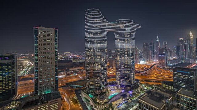 Panorama showing futuristic Dubai Downtown and finansial district skyline aerial night timelapse.