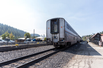 Train on the tracks near parking lot waits for passengers to board