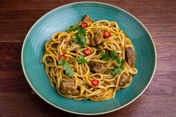 Peruvian pasta with meat cut with knife