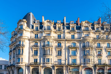 Fototapeta na wymiar Paris, typical facade and dome, beautiful building boulevard Richard-Lenoir, with a public park 