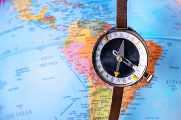 Compass on top of world map. Magnetic compass on world map.