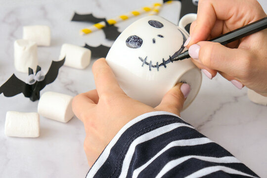 Female Hands Paint On White Cup Scary Jacks Face DIY For Kids Halloween Home Activities Holiday Art Children Craft Handmade Decorations Step By Step Socially Distanced At Home