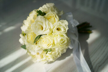 bouquet of white roses with ribbon. traditional wedding bouquet of the bride. 