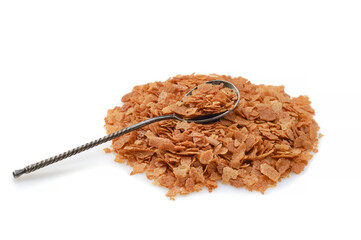 Heap of wafer or waffle crumb in a spoon on a white background.
