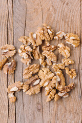 Peeled walnuts on wooden background