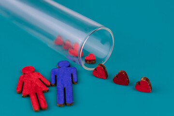 Figurine of a man and a woman and a test tube. The concept of conceiving a child by an artificial...