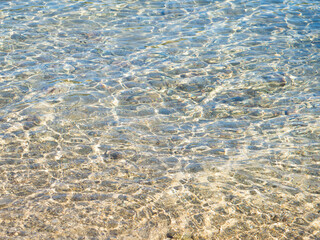 Transparent and crystal clear sea water of Adriatic sea, reflecting sunlight, water ripples