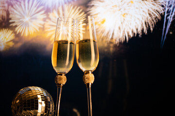 happy New Year champagne glasses and fireworks celebration background