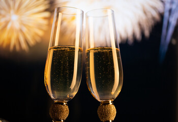 happy New Year champagne glasses and fireworks celebration background