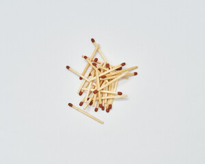 Piled up matches on white background