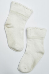 Pair of toddler white socks on a white background