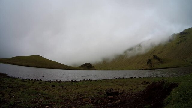 Time lapse video of fog in the mountains, lake at Corvo island, Azores, Portugal, travel destination.