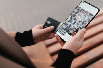 Young woman shopping online using smartphone