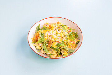 Italian pasta salad with arugula, slabs of Parmesan cheese, diced chicken and lots of olive oil