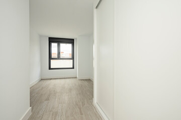 Empty room with freshly painted walls with wardrobe with small sliding doors