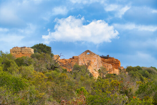 The ruins of the medieval Paderna Castle, rise up from the dry Mediterranean scrubland. Albufeira, Algarve, Portugal
