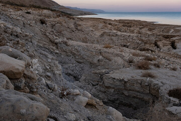 Fototapeta na wymiar View of Dead Sea sinkholes (or swallows), a deep hole in the ground formed abruptly along the coastline of the Dead Sea, Ein Gedi, Israel.