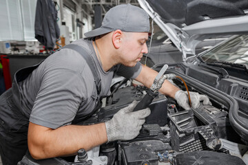 Fototapeta na wymiar Car mechanic changing oil - model and oil motion blurred.