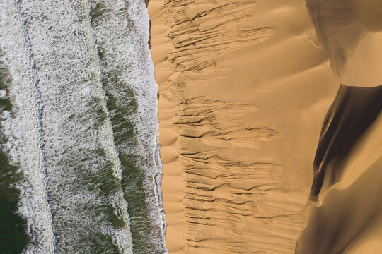 Aerial view of desert dunes and ocean, Lange Wand, Namibia.