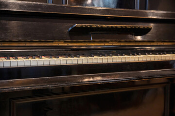 Piano keys on old wooden musical instrument. Piano keyboard closeup view