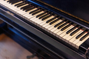 Fototapeta na wymiar Piano keys on old wooden musical instrument. Piano keyboard closeup view