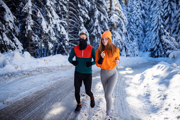 Fitness couple running outdoor at winter