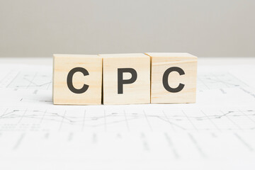 CPC wooden blocks word on grey background. CPC - cost per click, information concepts