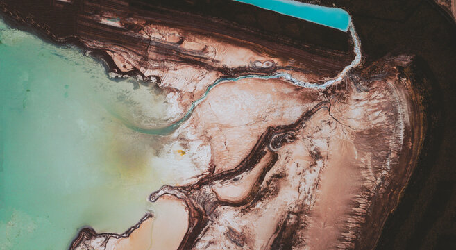 Aerial view of an abstract blue and turquoise clay lake, Art-sur-Meurthe, France.