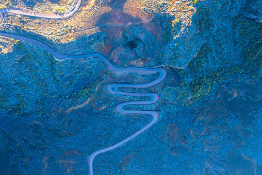 Aerial view of a serpentine road near Pas des Sables, Sainte Rose, Reunion.
