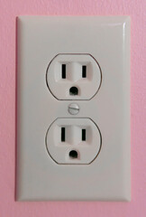 Electrical Plug on a Pink Wall