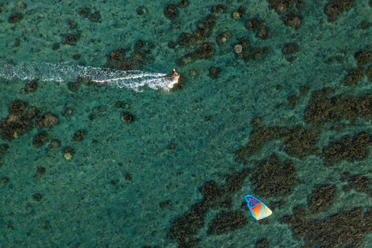 Aerial view of a person doing kite surfing along the coast at Plage de la Saline beach, Reunion.