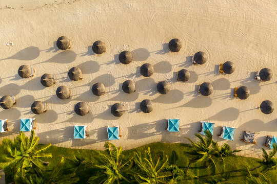 Aerial view of a tropical beach with parasols at Poste de Flacq, Mauritius.