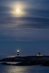 Full moon on the coast of Galicia, with lighthouse, natural rock arches, etc!