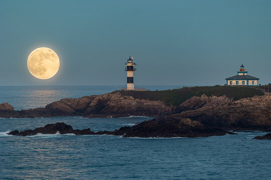 Full moon on the coast of Galicia, with lighthouse, natural rock arches, etc!