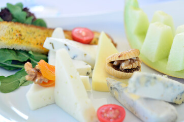 cheeses and melon with walnut tomato greens fig and garlic bread