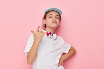 pretty young girl headphones in a white t-shirt and a cap childhood unaltered