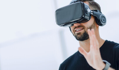 portrait of an amazed guy using a virtual reality headset isolat