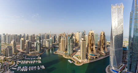 Dubai Marina and Harbour skyline architecture overview wealth luxury travel in United Arab Emirates with boats yacht panorama