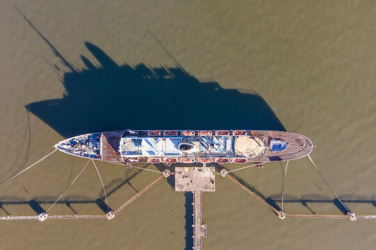 Aerial view of Cais da Matinha, a landmark ship docked along the Tagus river in Lisbon, Portugal.