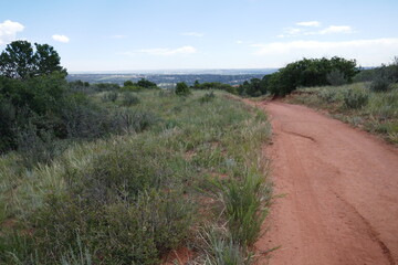Dry dusty hiking trail curves through plants