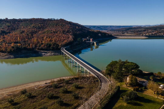 Aerial view of vehicles driving on the highway along Corbara lake (Lago di Corbara), Baschi, Terni, Italy.