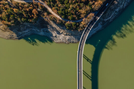 Aerial view of a road driving along the lake Corbara, Baschi, Umbria, Italy.