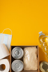 Box with food to support those in need during a pandemic, disaster on a bright background