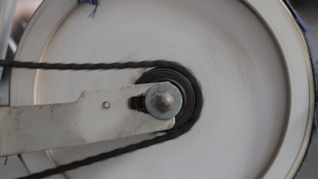 Detail footage from a spinning whell and chain on a old static bike 