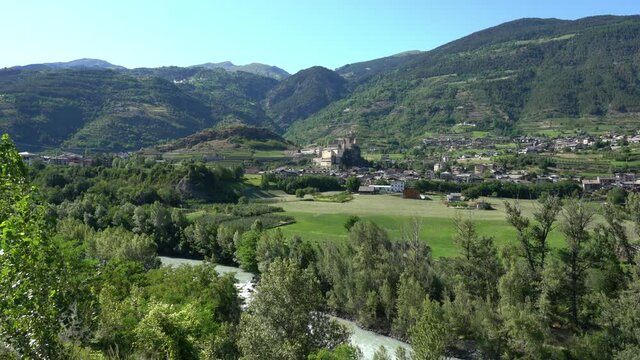 The village of Saint Pierre with its beautiful castle on a summer afternoon. Aosta Valley, northern Italy.