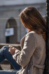Woman reading the banks of the Limmat river in Zurich