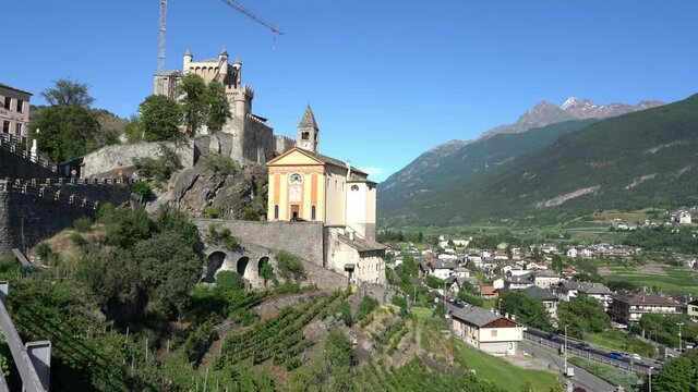 The village of Saint Pierre with its beautiful castle on a summer afternoon. Aosta Valley, northern Italy.