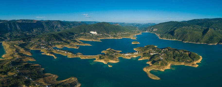 Panoramic aerial view of small settlements along the coast of Rama Lake, Bosnia and Herzegovina.